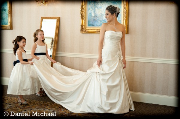Bride with Flower girls holding dress