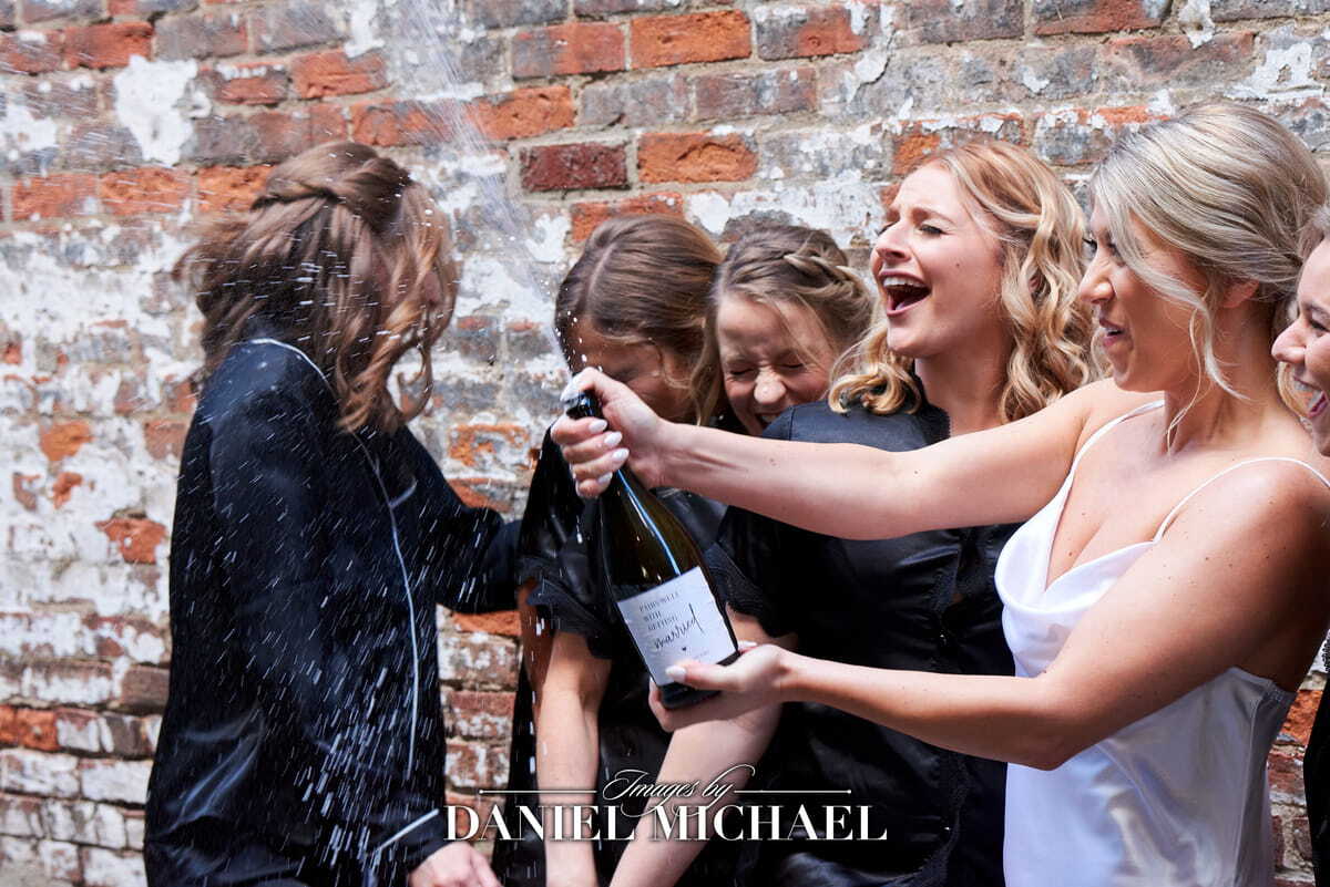 Woman popping champagne at a wedding