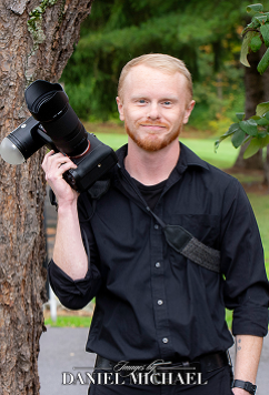 Tyler Boggs smiling while holding a camera